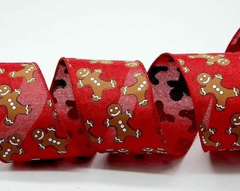 May include: Red ribbon with a repeating pattern of gingerbread men. The gingerbread men are brown with white accents and smiling faces. The ribbon has a festive look, perfect for holiday crafts and gift wrapping.
