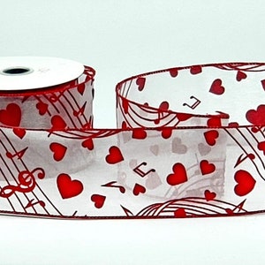 May include: A roll of sheer white ribbon with a red musical note and heart pattern. The ribbon is edged in red and features musical notes and red hearts. Perfect for Valentine's Day or music-themed crafts.