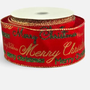 May include: A spool of red fabric ribbon featuring the repeating text Merry Christmas in alternating glittery green and metallic gold script. The ribbon edges are finished with a thin, metallic gold wire trim, providing structure to the fabric.
