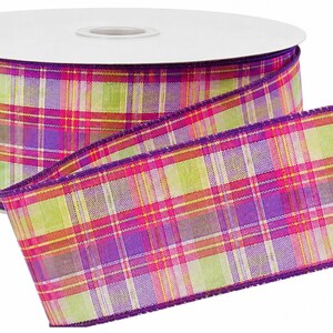 May include: A spool of wired ribbon featuring a vibrant plaid pattern in shades of lime green, bright magenta, and deep purple. The fabric has a woven texture with a distinct grid design and finished edges in a solid purple hue, wound on a white core.