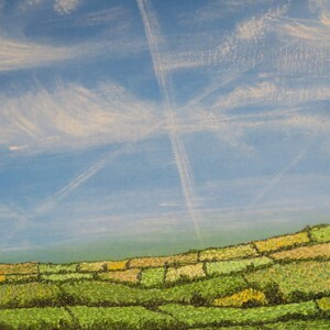 May include: An oil painting of a landscape featuring a blue sky with white clouds and contrails. The lower part of the painting shows green and yellow fields, creating a patchwork effect. The artwork evokes a rural scene.