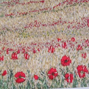May include: A textile artwork showing a field of wheat and red poppies. The piece uses textured stitching in beige, green, and red. The poppies are a bright red, and the wheat field is a light beige. The artwork is a close-up view.