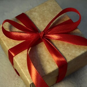 Kraft gift box with red ribbon — packaging for the felted Jack Russell miniature.