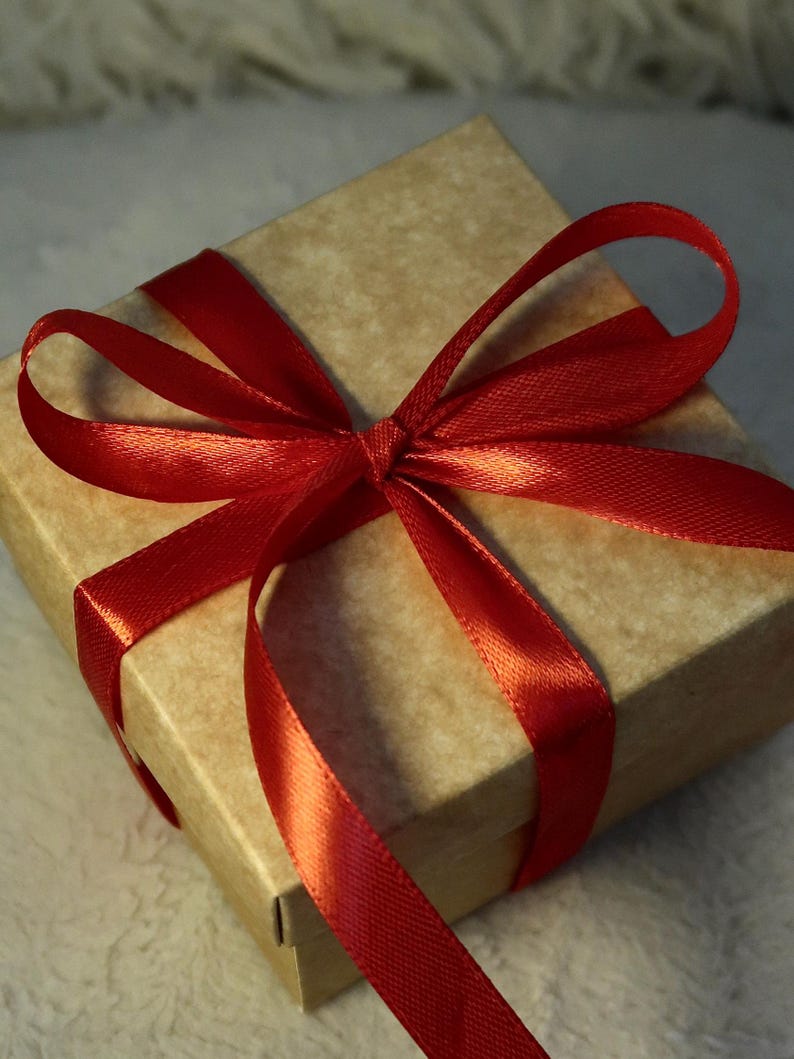 Kraft gift box with red ribbon — packaging for the felted Jack Russell miniature.