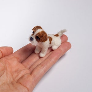 Tiny Jack Russell miniature held in a hand to show its small size, needle felted wool dog sculpture about 4–4.5 cm