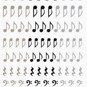 May include: A sheet of nail decals featuring rows of musical symbols including treble clefs, notes, rests, bass clefs, and whole notes in beige, black, and gray. The text GreatNails101.com 17FDMN101 and Made in MT USA 2017 (C) is at the bottom.