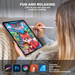 Woman using a stylus to digitally color a cute fox holding a glowing lantern beneath a pink torii gate on a tablet