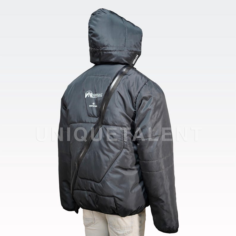 May include: Black hooded puffer jacket with a diagonal zipper and a logo on the back. The jacket has a quilted design and a strap across the shoulder. The text "UNIQUETALENT" is visible on the lower right side of the jacket.