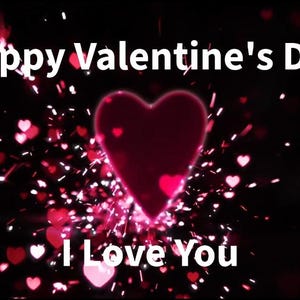 May include: A digital graphic with a black background and red hearts. The text "Happy Valentine's Day" and "I Love You" are displayed in white. A large, glowing red heart is in the center, surrounded by smaller hearts and sparkles.