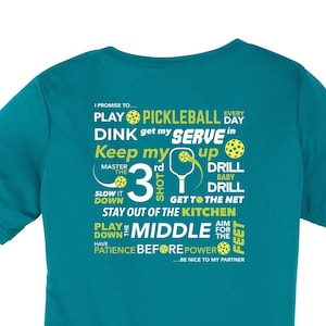 May include: Teal blue women's t-shirt with a white graphic print of pickleball-related text and images. The text includes "Play Pickleball Every Day", "Dink Get My Serve In", "Keep My Up", "Master The 3rd Shot", "Slow It Down", "Get To The Net", "Stay Out Of The Kitchen", "Play The Middle", "Aim For The Feet", "Have Patience Before Power", and "Be Nice To My Partner".