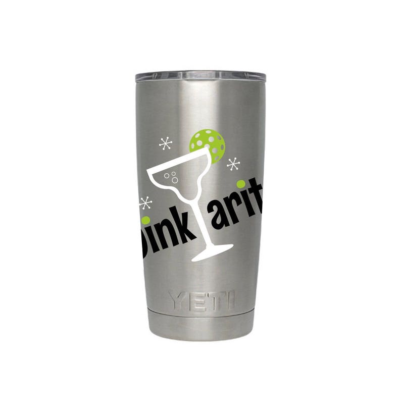 May include: A silver Yeti tumbler with a white margarita glass and a green pickleball graphic. The text "Drink Arit" is printed on the tumbler.