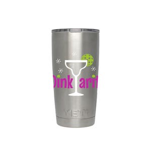 May include: A stainless steel tumbler with a white silhouette of a margarita glass and the text "Dink ari" in pink. The tumbler has a green pickleball and white stars around the glass.