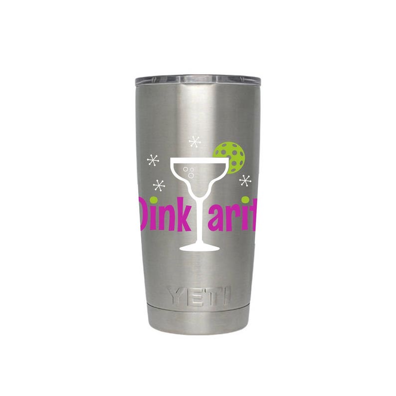 May include: A stainless steel tumbler with a white silhouette of a margarita glass and the text "Dink ari" in pink. The tumbler has a green pickleball and white stars around the glass.