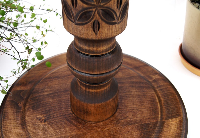 Close-up detail of deep hand-carved geometric motifs on a dark wooden plant column. Solid hardwood texture with a silky oil wax finish, showing the craftsmanship of the turned pillar design.