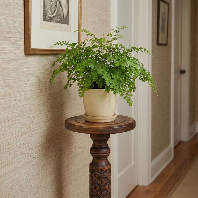 Close-up detail of deep hand-carved geometric motifs on a dark wooden plant column. Solid hardwood texture with a silky oil wax finish, showing the craftsmanship of the turned pillar design.