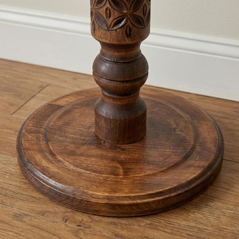 Close-up detail of deep hand-carved geometric motifs on a dark wooden plant column. Solid hardwood texture with a silky oil wax finish, showing the craftsmanship of the turned pillar design.