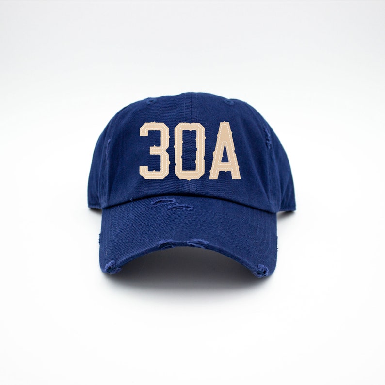 May include: A navy blue distressed baseball cap with a tan embroidered "30A" on the front.