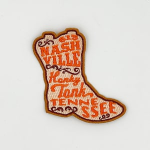 May include: A brown boot-shaped patch with orange embroidered text that reads "615 Nashville Honky Tonk Tennessee".
