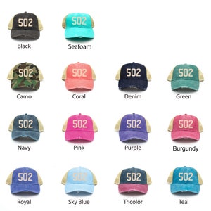 May include: A set of 14 trucker hats in various colors, each with a beige mesh back and a white embroidered "502" on the front.