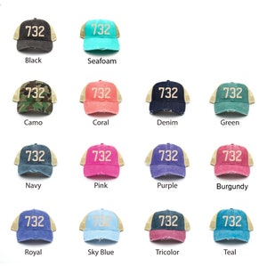 May include: A set of 12 trucker hats with a variety of colors, including black, seafoam, camo, coral, denim, green, navy, pink, purple, burgundy, royal, sky blue, tricolor, and teal. Each hat features the number "732" embroidered on the front.