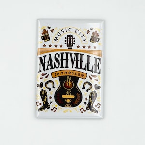 May include: A white rectangular magnet with a brown guitar, boots, and beer mugs. The text reads "Music City Nashville Tennessee".
