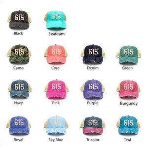 May include: A collection of trucker hats in various colors, each featuring the number "615" in a contrasting color. Colors include black, seafoam, camo, coral, denim, green, navy, pink, purple, burgundy, royal, sky blue, tricolor, and teal.