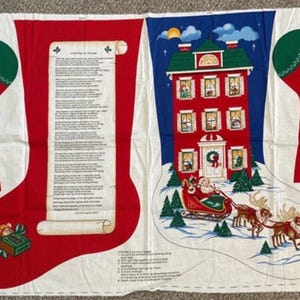 May include: A printed fabric panel for sewing Christmas stockings, featuring red stockings with green cuffs, a scroll with text, a red house, and Santa in a sleigh with reindeer. The design includes illustrations of Santa, gifts, and instructions.