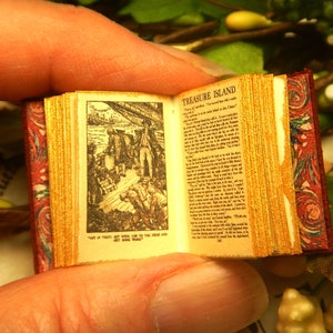 Treasure Island: a leather miniature book in 12th scale, hand bound in stitched red with antique illustration of pirates and sea adventure