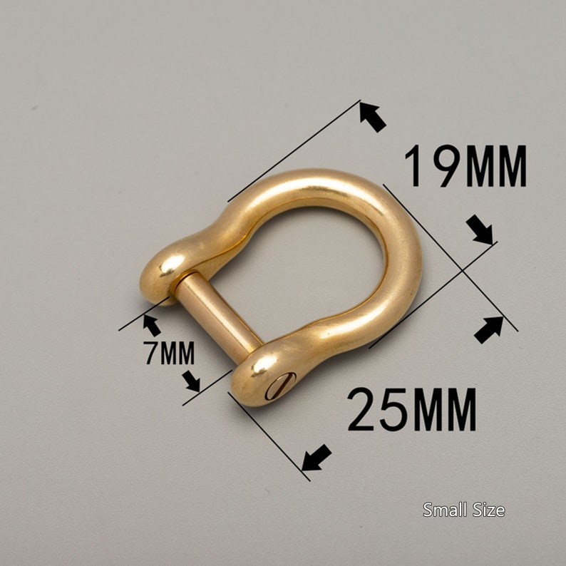 May include: A small, gold-colored D-shackle with a pin. The shackle measures 25mm long, 19mm wide, and 7mm thick. The text "Small Size" is also visible.
