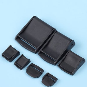 May include: Assortment of six black plastic side release buckles in various sizes. The buckles are commonly used for straps, bags, and other DIY projects.