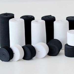May include: A collection of black and white elastic bands rolled up in various sizes. The elastic bands are perfect for sewing, crafting, and other DIY projects.