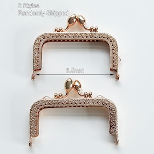 May include: Two gold-toned metal purse frames with ornate designs. Each frame measures 8.5 mm wide. 2 Styles Randomly Shipped.