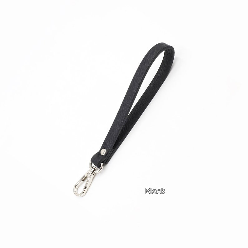 May include: A black leather strap with a silver swivel clasp. The strap is about 18 inches long.
