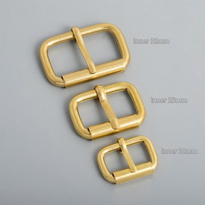 May include: Three gold metal belt buckles in different sizes. The buckles are 32mm, 25mm, and 20mm wide. Inner 32mm, Inner 25mm, Inner 20mm.