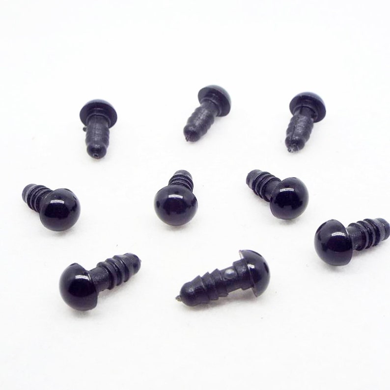 May include: Ten black plastic safety eyes with a screw-on back. The eyes are round and have a glossy finish.