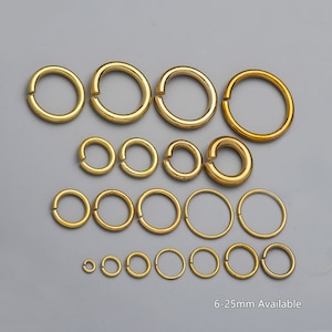 May include: Assortment of gold jump rings in various sizes, ranging from 6 to 25 mm.  These rings are perfect for jewelry making, crafting, and DIY projects.
