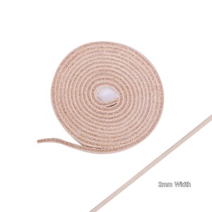 May include: A roll of light brown leather cord, 2 mm wide. The cord is rolled up and the end is extended to show the width.