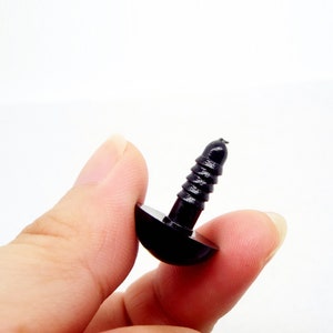 May include: Black plastic safety eyes with a screw-on back. The eyes are about 1 inch in diameter.