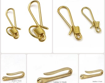 May include: Three gold-colored metal U-shaped hooks of different sizes. The smallest hook is 46mm long, the medium hook is 80mm long, and the largest hook is 72mm long.