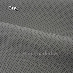 May include: Gray fabric with a small, repeating dot pattern. The fabric is textured and has a slight sheen.