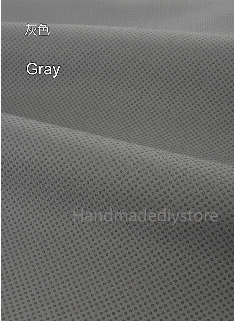 May include: Gray fabric with a small, repeating dot pattern. The fabric is textured and has a slight sheen.