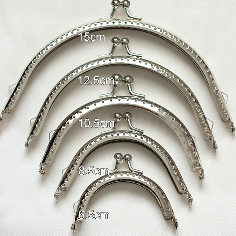 May include: Five silver purse frames in different sizes, measuring 6.5 cm, 8.5 cm, 10.5 cm, 12.5 cm, and 15 cm.