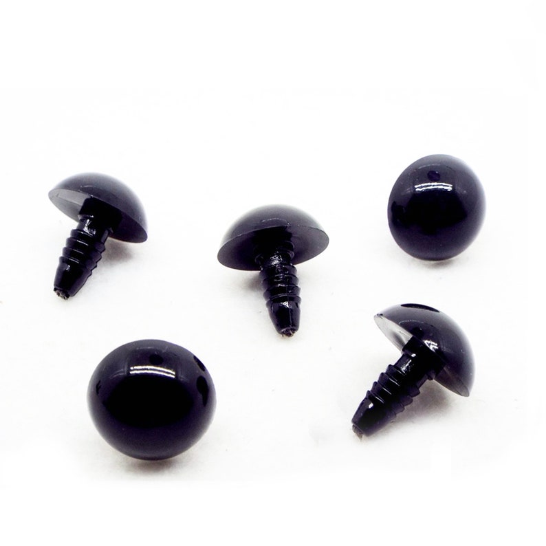 May include: Five black plastic safety eyes with a screw back. The eyes are round and have a shiny finish.