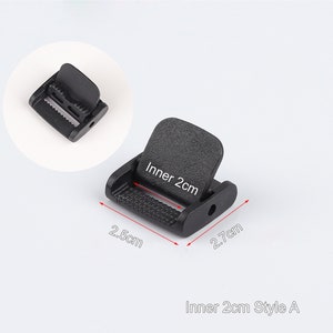 May include: Black plastic buckle with a 2 cm inner width. The buckle measures 2.5 cm wide and 2.7 cm long.  Inner 2cm Style A.