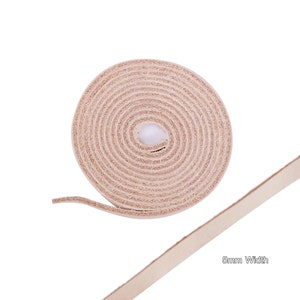 May include: A roll of light brown leather cord, 5mm wide, unfurling to show the length of the cord.