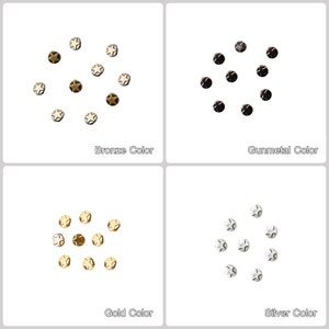 May include: Four sets of star-shaped metal studs in four different colors: bronze, gunmetal, gold, and silver. Each set is arranged in a circle.