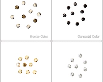 May include: Four sets of star-shaped metal studs in four different colors: bronze, gunmetal, gold, and silver. Each set is arranged in a circle.