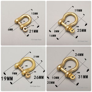 May include: Four different sizes of gold-colored metal D-rings with measurements in millimeters. The D-rings are shown against a white background.