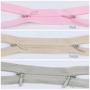 Pu&ograve; includere: Tre nastri per cerniera lampo in rosa, beige e grigio chiaro. Ogni nastro ha un cursore per cerniera lampo argentato con una piccola linguetta appuntita.