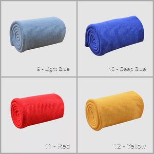 May include: Four rolled up fabric swatches in different colors: light blue, deep blue, red, and yellow. The swatches are labeled with their corresponding colors and numbers.